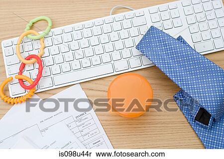 Stock Photography - Computer keyboard with baby equipment and tie. Fotosearch