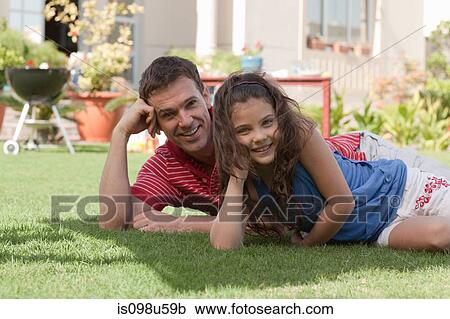 Stock Image - Father and daughter in the garden. Fotosearch
