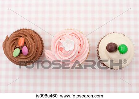 Stock Image - Iced cupcakes. Fotosearch