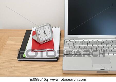 Laptop, notebooks and alarm clock View Large Photo Image Stock Photography - Laptop, notebooks and alarm clock. Fotosearch