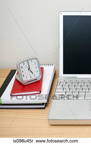 Stock Photography - Laptop, notebooks and alarm clock. Fotosearch