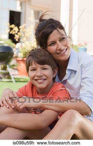 Mother and son in the garden View Large Photo Image Stock Image - Mother and son in the garden. Fotosearch