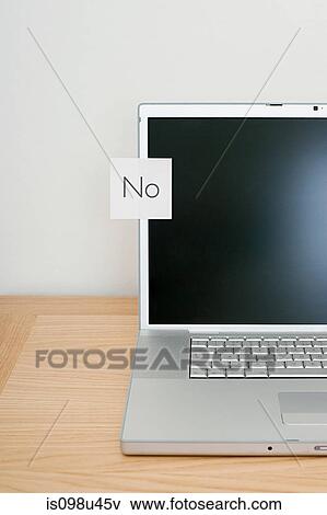 Stock Photo - No written on adhesive note on laptop. Fotosearch