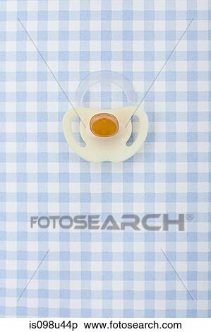Pacifier on blue checker pattern View Large Photo Image Stock Photography - Pacifier on blue checker pattern. Fotosearch