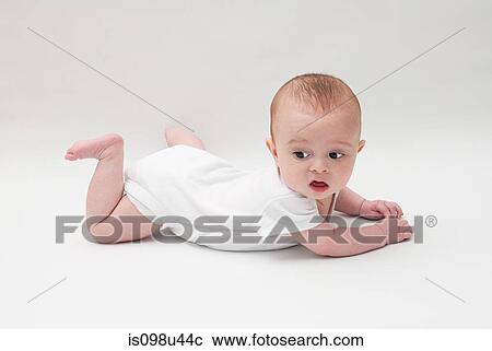 Portrait of a baby boy lying on his front View Large Photo Image Stock Image - Portrait of a baby boy lying on his front. Fotosearch