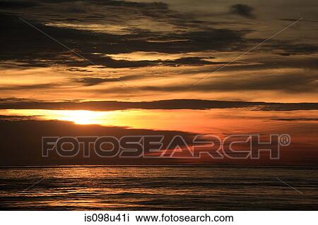 Stock Image - Sunset over sea, singapore. Fotosearch
