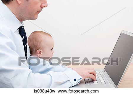 Working father and baby at laptop View Large Photo Image Stock Photo - Working father and baby at laptop. Fotosearch