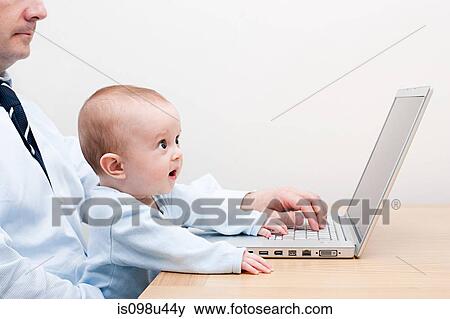 Working father and baby at laptop View Large Photo Image Stock Photo - Working father and baby at laptop. Fotosearch