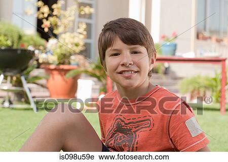 Young boy in the garden View Large Photo Image Stock Image - Young boy in the garden. Fotosearch