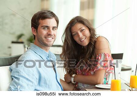 Young couple at dining table View Large Photo Image Stock Image - Young couple at dining table. Fotosearch