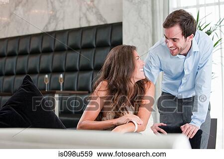 Young couple laughing at dinner table View Large Photo Image Stock Photo - Young couple laughing at dinner table. Fotosearch