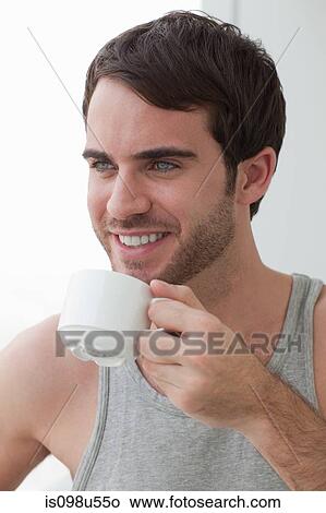 Picture - Young man with coffee. Fotosearch