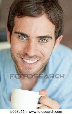 Stock Image - Young man with coffee. Fotosearch