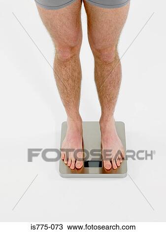 Man on scales View Large Photo Image Stock Image - Man on scales. Fotosearch