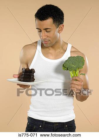 Man with chocolate cake and broccoli View Large Photo Image Stock Image - Man with chocolate cake and broccoli. Fotosearch