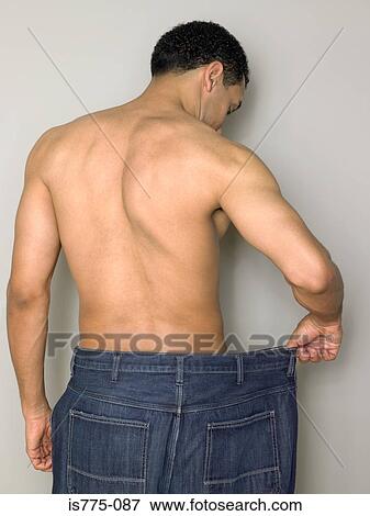Stock Photo - Man with loose jeans. Fotosearch