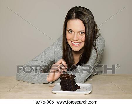 Young woman with chocolate cake View Large Photo Image Stock Photography - Young woman with chocolate cake. Fotosearch
