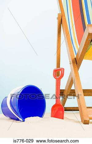 Stock Photo - Bucket and spade and deckchair. Fotosearch