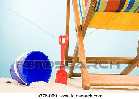 Bucket and spade and deckchair View Large Photo Image Stock Photo - Bucket and spade and deckchair. Fotosearch