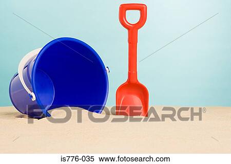 Stock Photography - Bucket and spade on beach. Fotosearch