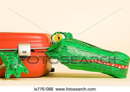 Stock Photo - Inflatable crocodile in a suitcase. Fotosearch