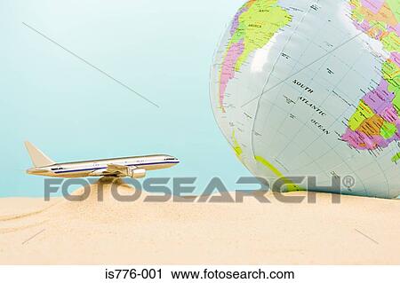 Stock Image - Model aeroplane and globe. Fotosearch
