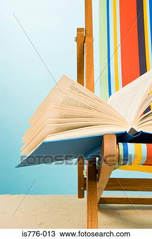 Open book on a deckchair View Large Photo Image Stock Image - Open book on a deckchair. Fotosearch