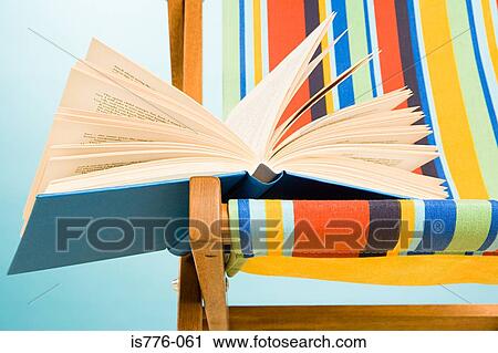Open book on a deckchair View Large Photo Image Stock Image - Open book on a deckchair. Fotosearch