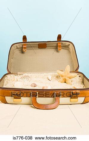 Starfish shells and sand in a suitcase View Large Photo Image Stock Photo - Starfish shells and sand in a suitcase. Fotosearch