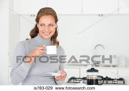 Woman having coffee View Large Photo Image Stock Photo - Woman having coffee. Fotosearch