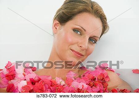 Woman in a bath with petals View Large Photo Image Stock Image - Woman in a bath with petals. Fotosearch