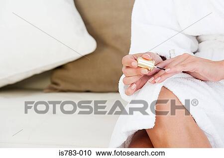Woman painting her fingernails View Large Photo Image Stock Image - Woman painting her fingernails. Fotosearch