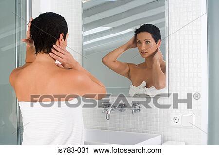 Woman styling her hair View Large Photo Image Stock Image - Woman styling her hair. Fotosearch