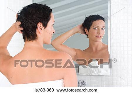 Woman styling her hair View Large Photo Image Stock Image - Woman styling her hair. Fotosearch