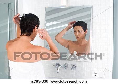 Woman styling her hair View Large Photo Image Stock Photograph - Woman styling her hair. Fotosearch