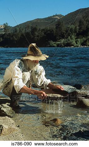 Stock Image - Man panning for gold. Fotosearch