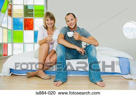 Couple having tea on bed View Large Photo Image Stock Image - Couple having tea on bed. Fotosearch