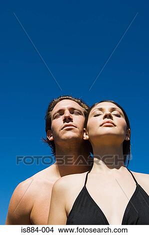 Couple in sunlight with eyes closed View Large Photo Image Picture - Couple in sunlight with eyes closed. Fotosearch