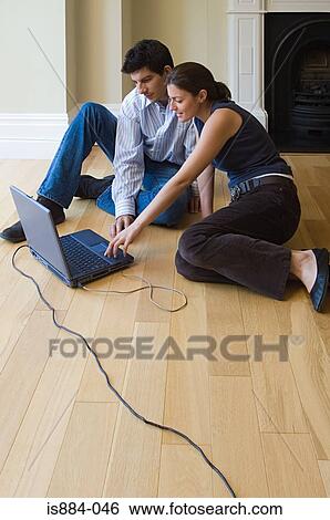 Stock Photograph - Couple using laptop. Fotosearch