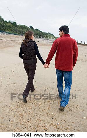 Couple walking on beach View Large Photo Image Stock Image - Couple walking on beach. Fotosearch