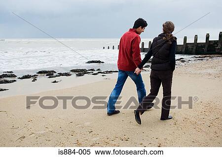 Couple walking on beach View Large Photo Image Stock Photography - Couple walking on beach. Fotosearch