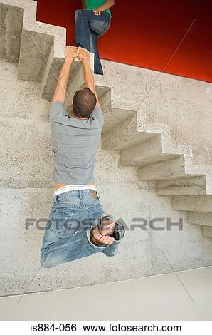 Man hanging onto concrete staircase View Large Photo Image Stock Photograph - Man hanging onto concrete staircase. Fotosearch