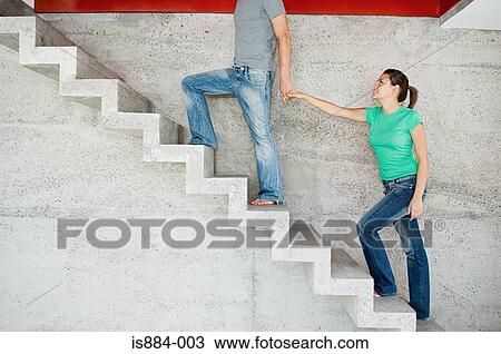 Man leading woman upstairs View Large Photo Image Stock Image - Man leading woman upstairs. Fotosearch