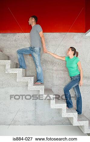Man leading woman upstairs View Large Photo Image Stock Photo - Man leading woman upstairs. Fotosearch