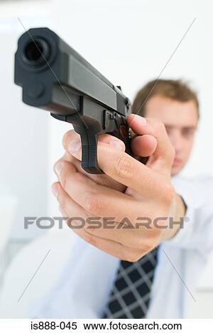 Stock Photography - Man aiming handgun. Fotosearch