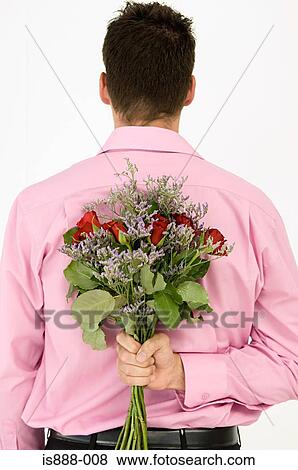 Man holding bunch of flowers View Large Photo Image Stock Photo - Man holding bunch of flowers. Fotosearch