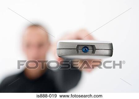 Stock Photo - Man holding remote control. Fotosearch