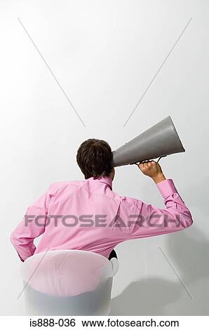 Man listening through megaphone View Large Photo Image Stock Photograph - Man listening through megaphone. Fotosearch