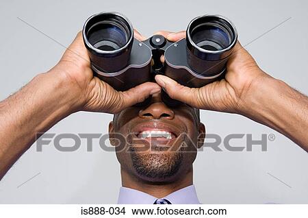 Picture - Man looking through binoculars. Fotosearch