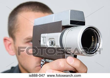 Man using cine camera View Large Photo Image Stock Photo - Man using cine camera. Fotosearch